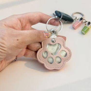 Leather paw keychain with storage compartment