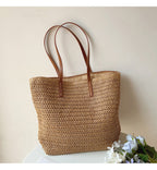 Woven basket bag with leather handles