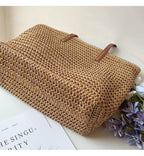 Woven basket bag with leather handles