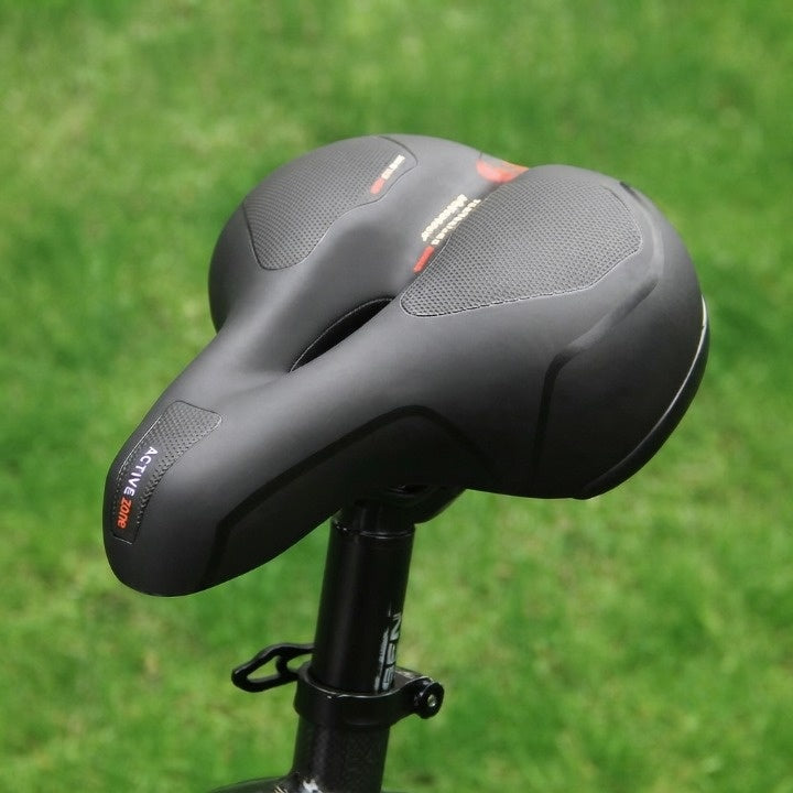 Ergonomic bicycle saddle with padding and reflector strips