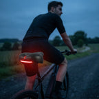 Ergonomic bicycle saddle with padding and reflector strips