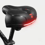 Ergonomic bicycle saddle with padding and reflector strips