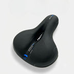 Ergonomic bicycle saddle with padding and reflector strips