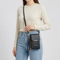 Crossbody phone bag with touchscreen window and card slots, faux leather
