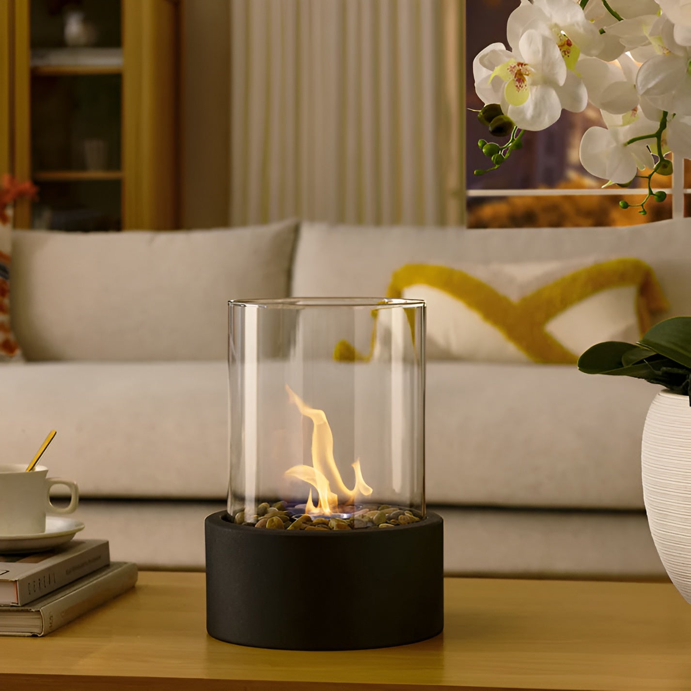 Table fireplace with glass cylinder and metal base