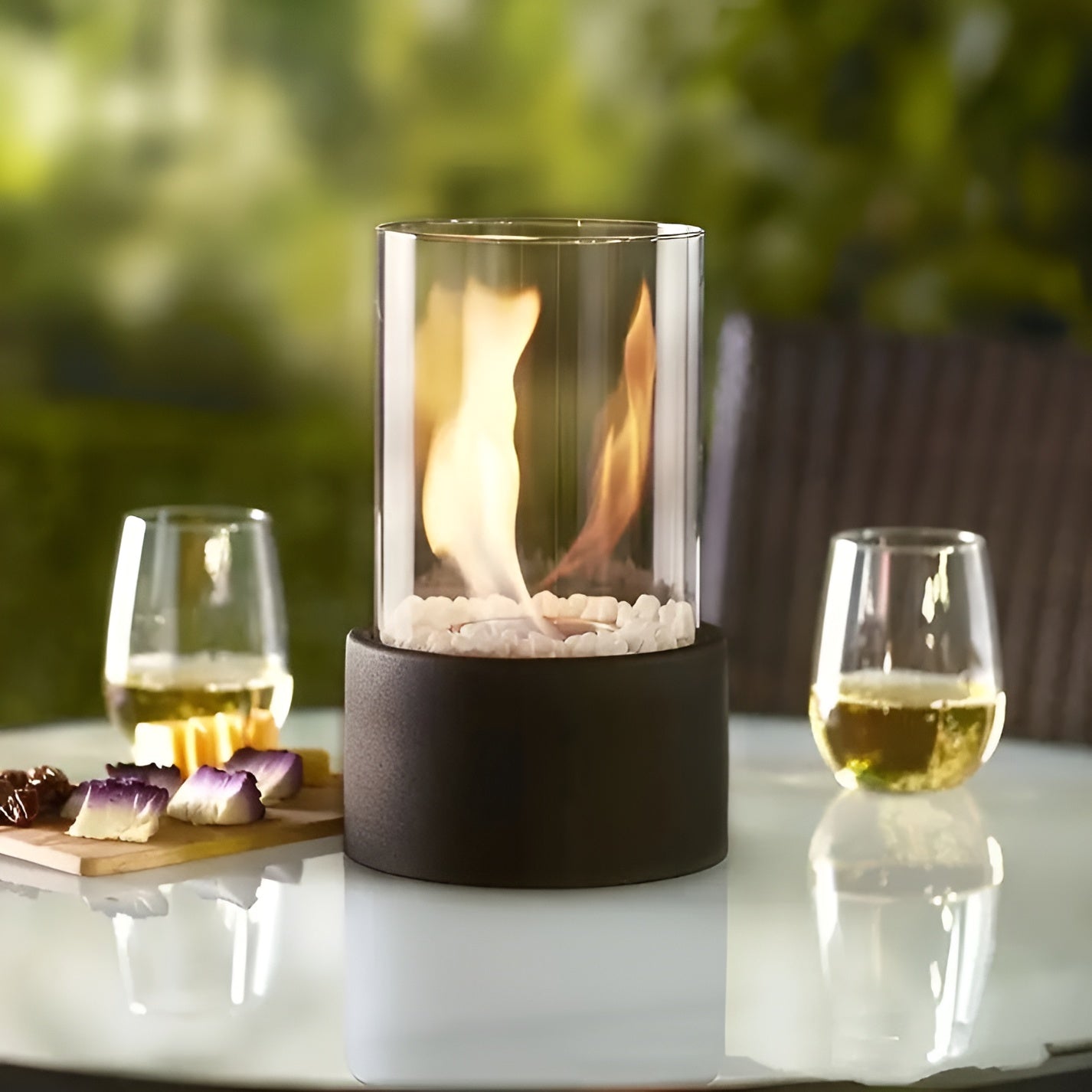 Table fireplace with glass cylinder and metal base