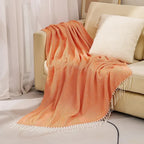 Cotton sofa throw with striped pattern and fringes