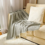 Cotton sofa throw with striped pattern and fringes