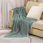 Cotton sofa throw with striped pattern and fringes