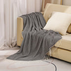 Cotton sofa throw with striped pattern and fringes