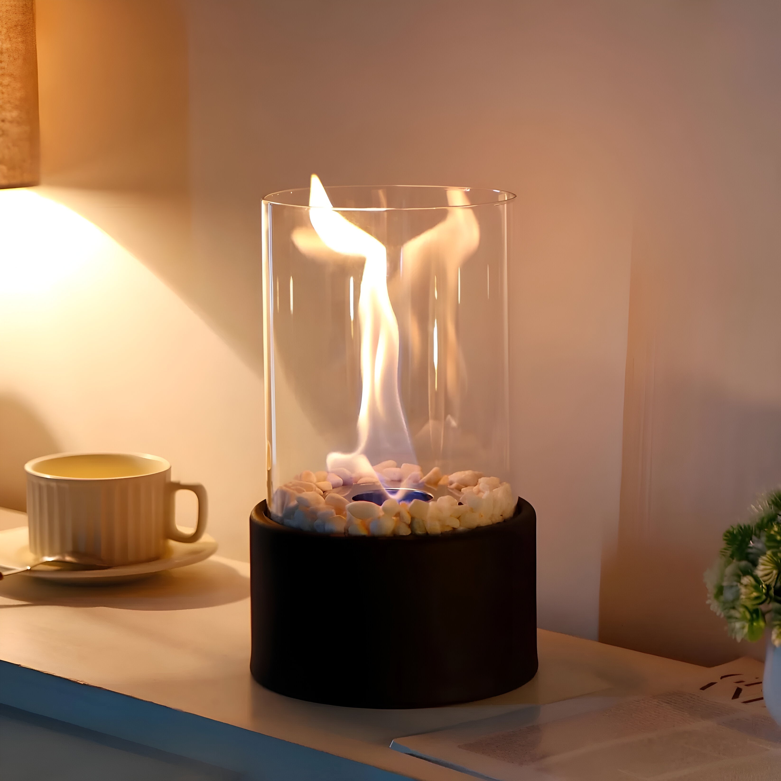 Table fireplace with glass cylinder and metal base