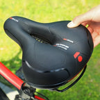 Ergonomic bicycle saddle with padding and reflector strips