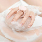 Shower sponge with massage knobs and ergonomic handle