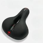 Ergonomic bicycle saddle with padding and reflector strips