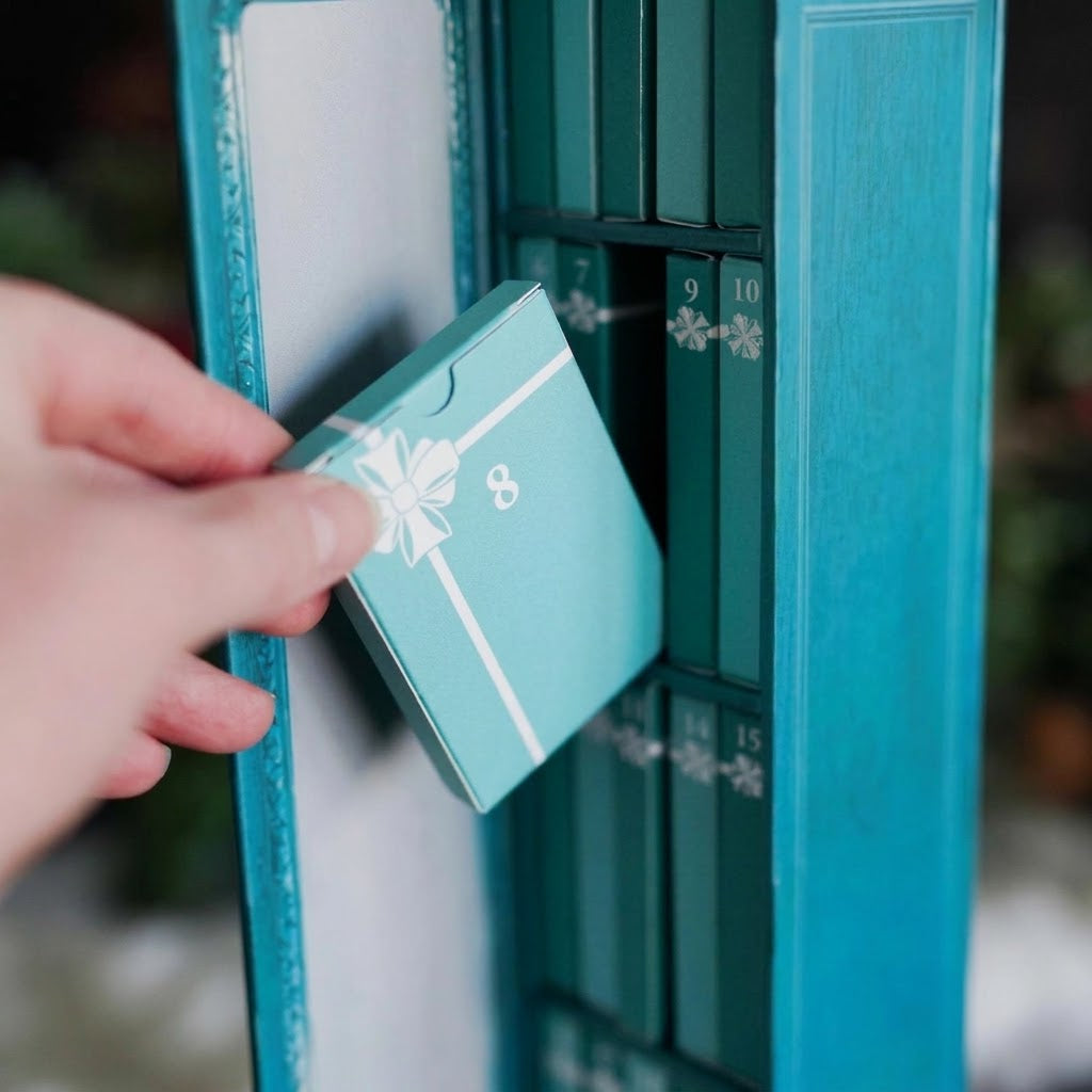 Book advent calendar with 25 mini books on a bookshelf, turquoise