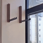Foldable wall-mounted wooden coat rack with a space-saving design