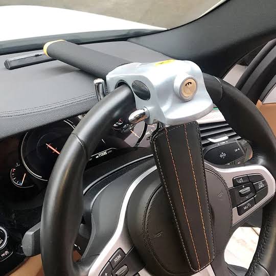 Steering wheel lock with triple locking mechanism