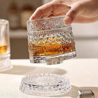 Rotating whisky glass with embossed crystal pattern