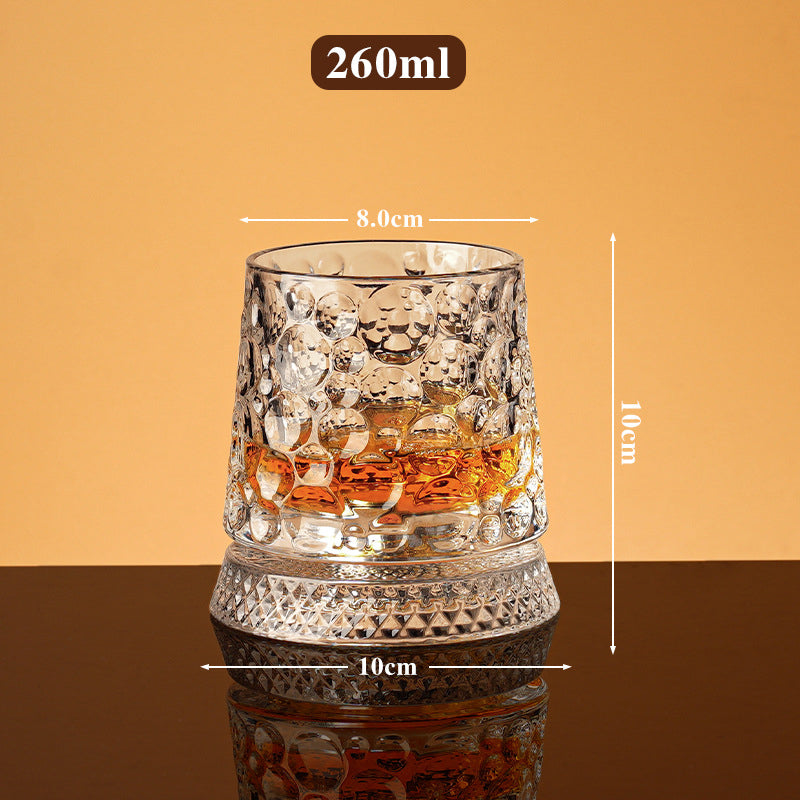 Rotating whisky glass with embossed crystal pattern