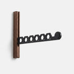 Foldable wall-mounted wooden coat rack with a space-saving design