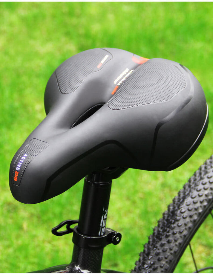 Ergonomic bicycle saddle with padding and reflector strips