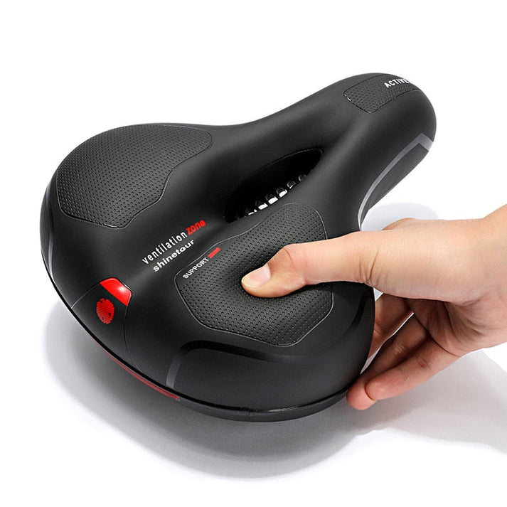 Ergonomic bicycle saddle with padding and reflector strips
